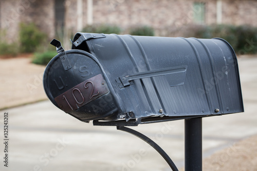 Mailbox that has been hit and damaged by car