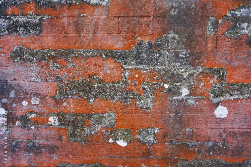 Dirty red brick wall with dark burnt patches horizontal architecture background texture