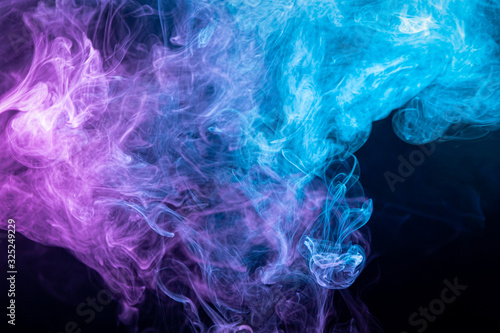 Dense multicolored smoke of purple and blue colors on a black isolated background. ART for your design project. Transparent creativity