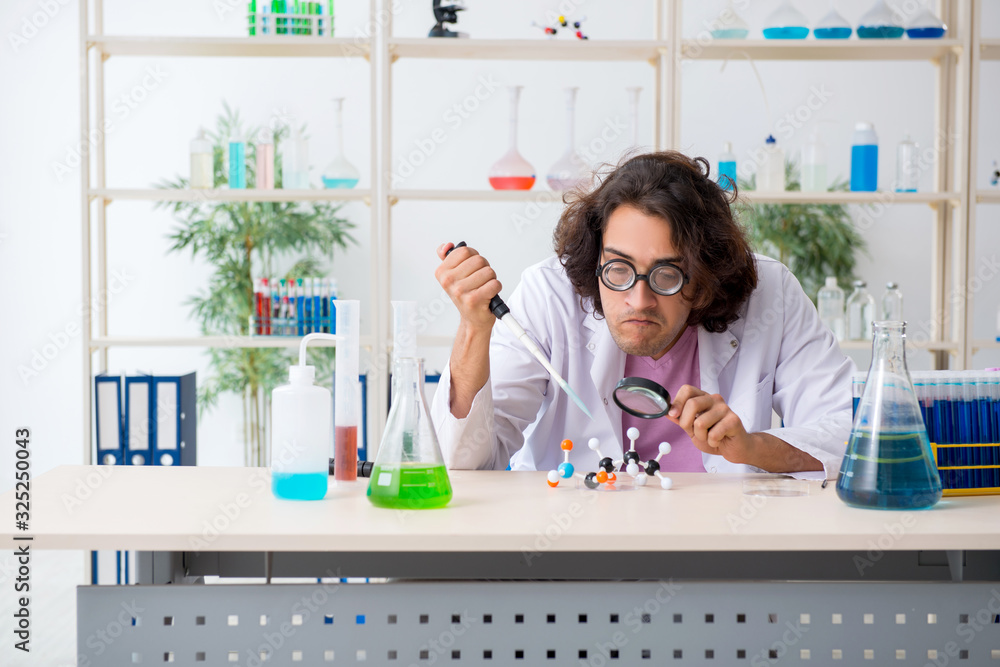 Funny male chemist working in the lab Funny male chemist working in the lab