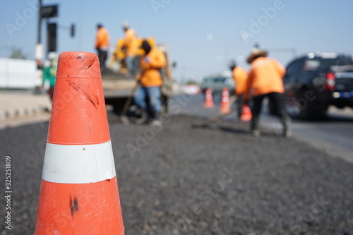 Blur image, repairing pavement mainly by manual labor