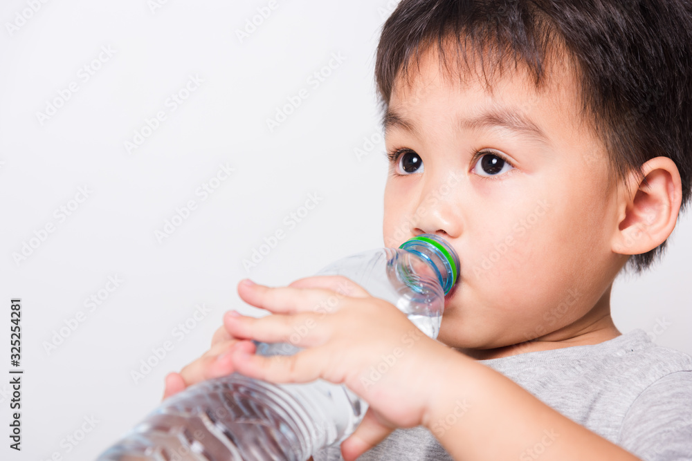 Closeup Asian face, Little children boy drinking water from Plastic bottle Closeup Asian face, Little children boy drinking water from Plastic bottle