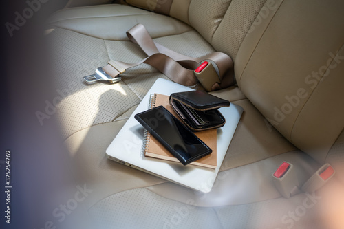 Obraz na płótnie View from outside of the car at valuables wallet, purse laptop or computer notebook , credit card and mobile phone , Windows that are rolled down are open invitations for thieves to enter your vehicle w salonie