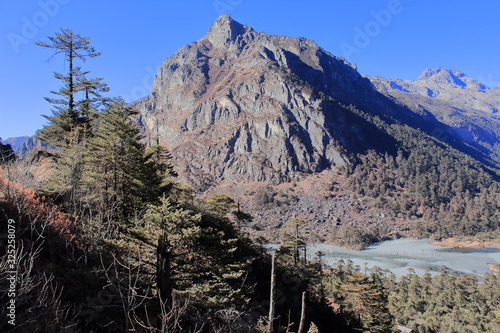 scenic landscape and birds eye view of madhuri lake or sangetsar tso lake or sangestar tso lake surrounded by hills in tawang, arunachal pradesh in india photo