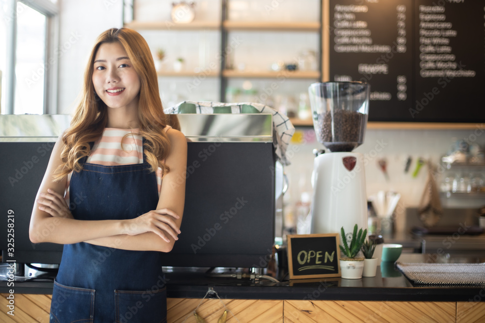 Portrait young Asian woman barista feeling happy smiling at urban cafe. Small business owner Korean girl in apron relax toothy smile Portrait young Asian woman barista feeling happy smiling at urban cafe. Small business owner Korean girl in apron relax toothy smile