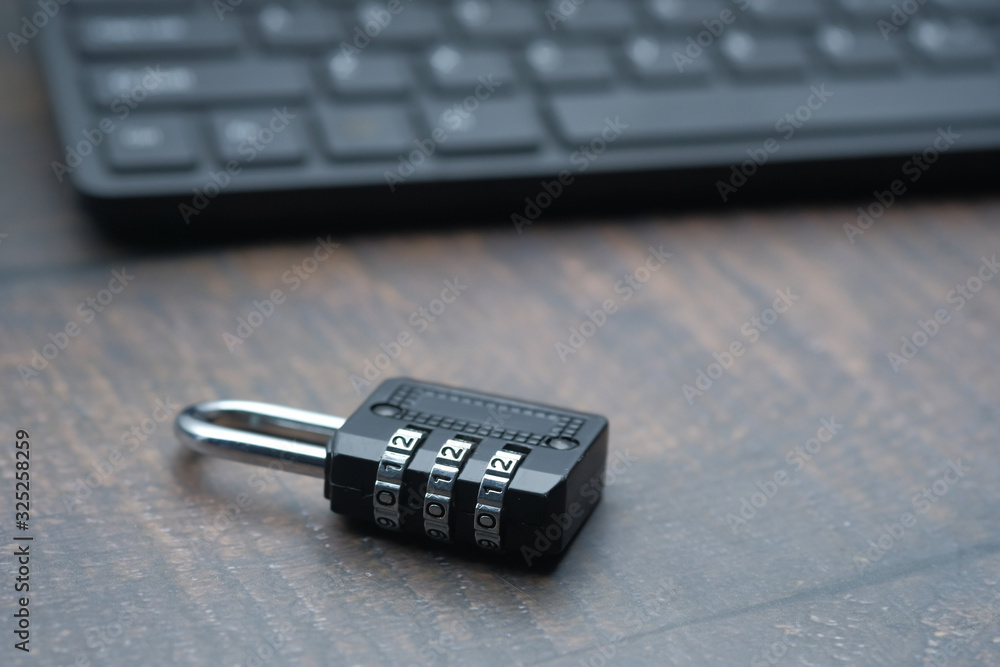 close up of padlock and keyboard on table close up of padlock and keyboard on table
