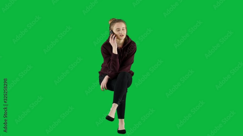 Young Woman Talking on The Phone Sitting on a Chair Green Screen Young Woman Talking on The Phone Sitting on a Chair Green Screen
