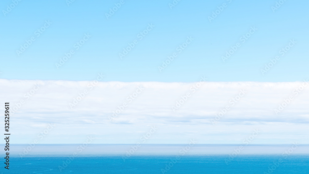 Long view of Pacific ocean horizon with white clouds Long view of Pacific ocean horizon with white clouds