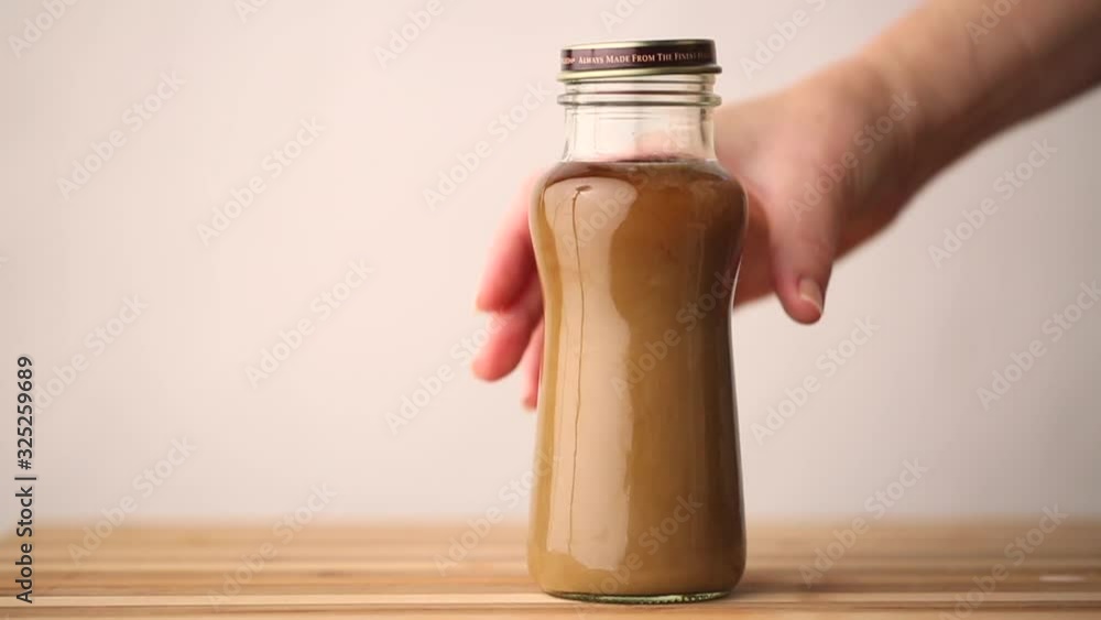 A lid is being placed on a coffee beverage and is ready for on the go. A lid is being placed on a coffee beverage and is ready for on the go.