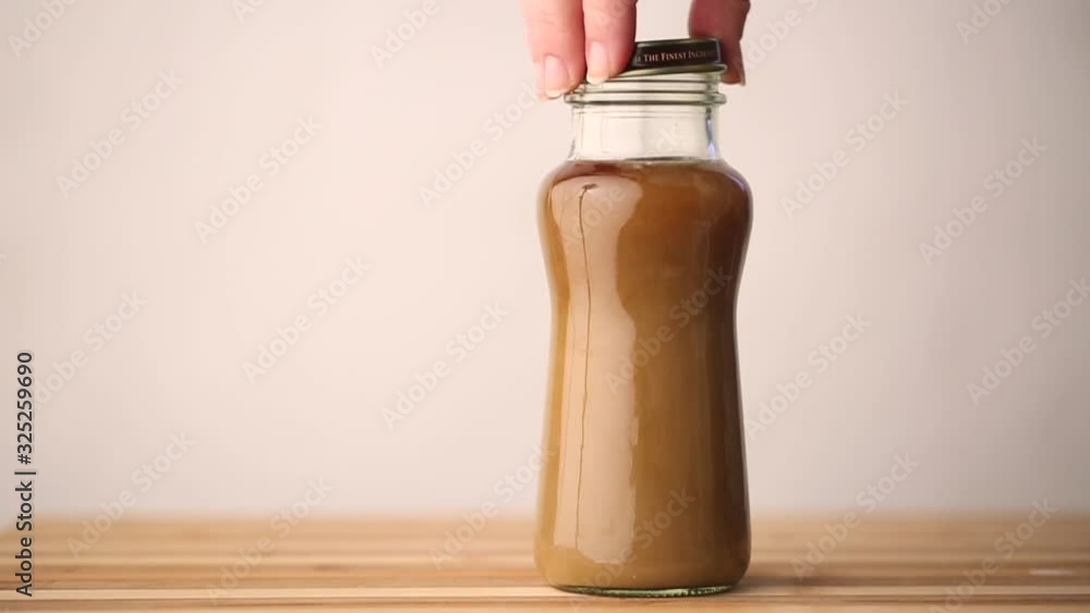 A lid is being placed on a coffee beverage in slow motion and is ready for on the go. A lid is being placed on a coffee beverage in slow motion and is ready for on the go.