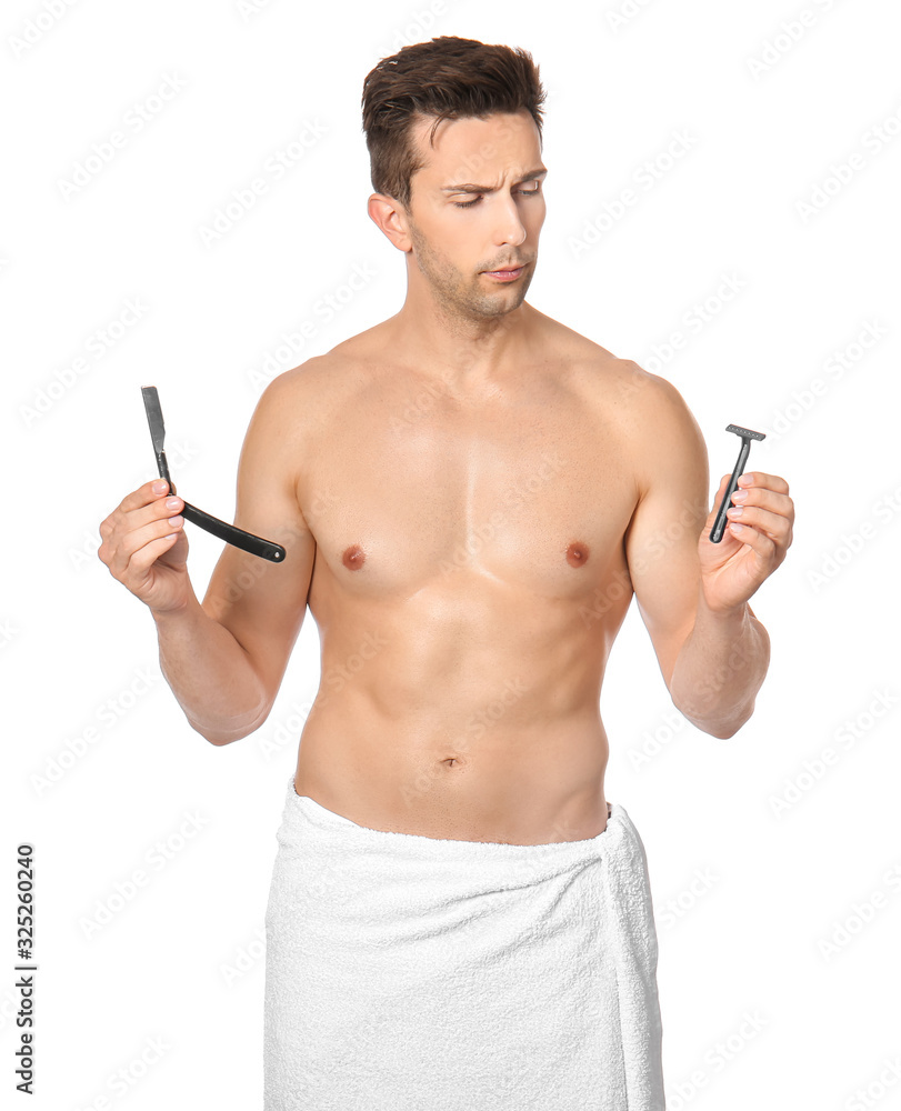 Fototapeta premium Handsome young man with different razors on white background