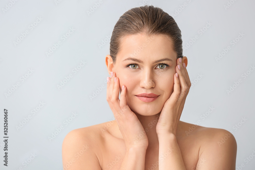 Beautiful young woman on light background. Concept of plastic surgery Beautiful young woman on light background. Concept of plastic surgery