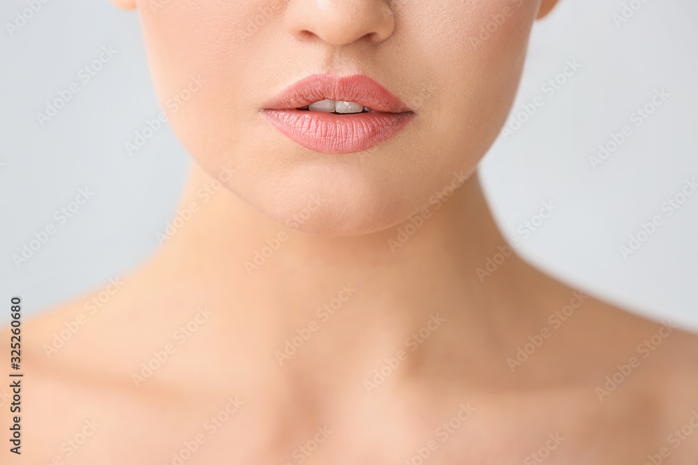 Beautiful young woman on light background, closeup. Concept of plastic surgery Beautiful young woman on light background, closeup. Concept of plastic surgery