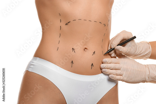 Plastic surgeon applying ma...
