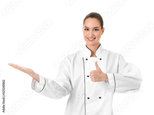 Beautiful female chef showing thumb-up on white background