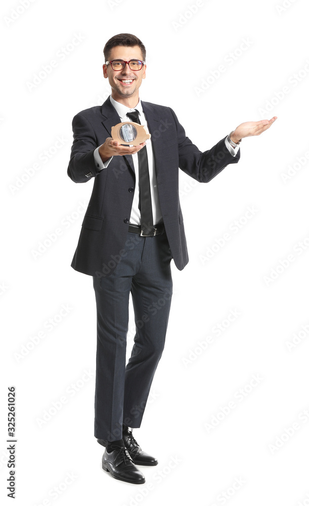 Happy male bank manager with piggy bank showing something on white background Happy male bank manager with piggy bank showing something on white background