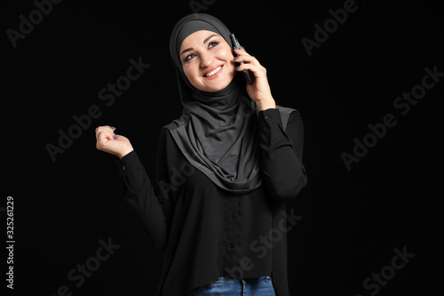 Young Arab woman talking by...