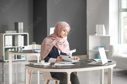 Young Arab woman working in...