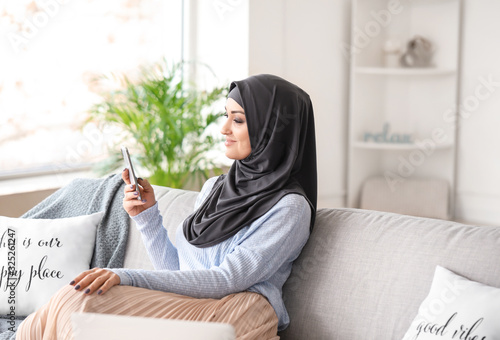Young Arab woman with mobil...