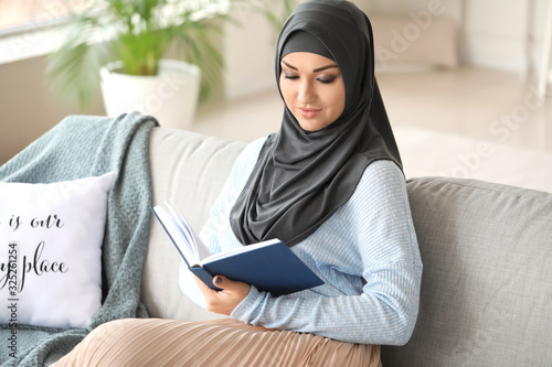 Young Arab woman reading bo...
