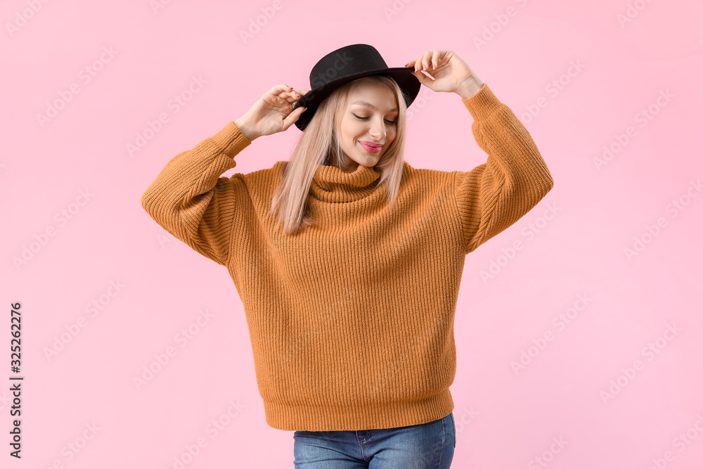 Young woman in warm sweater on color background Young woman in warm sweater on color background