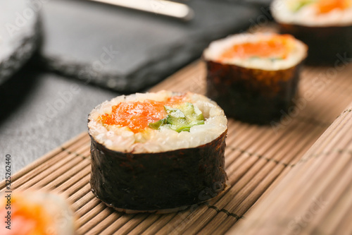 Tasty sushi rolls on table