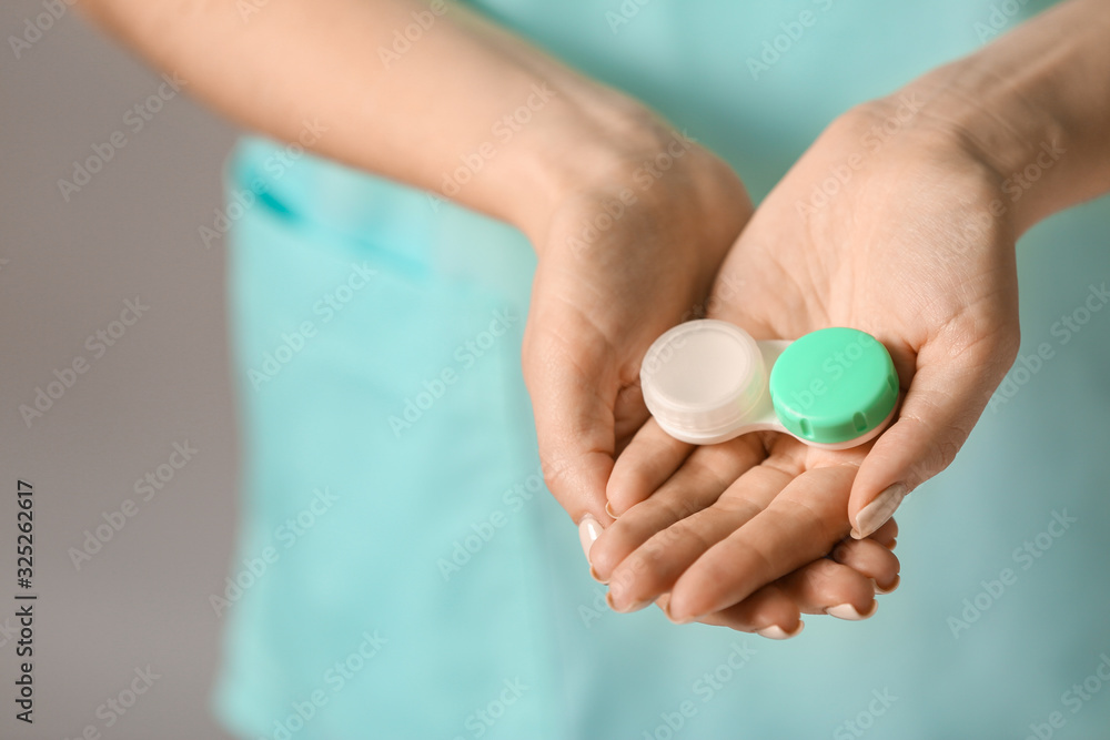 Woman holding container with contact lenses, closeup Woman holding container with contact lenses, closeup