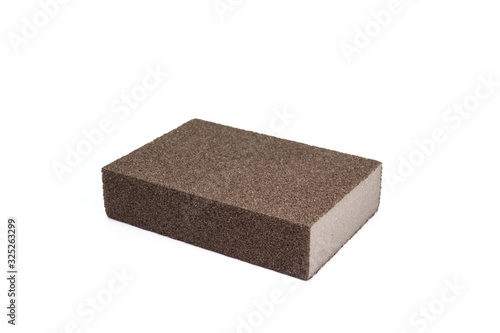 The close up of polishing sandpaper rough sponge block for kitchenware cleaning.