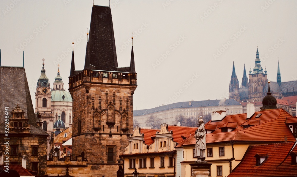 Details from the Prague, (Praha) Czech Republic “the City of a Hundred Spires,” skyline including red roofs, the Charles Bridge, Prague Castle, Strahov Monastery, and church of St. Francis of Assisi.