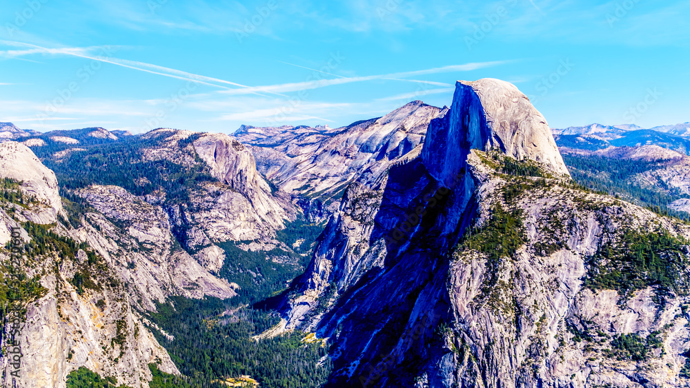 The Yosemite Valley in the Sierra Nevada Mountains with the famous Half Dome granite rock formation on the right. Viewed from Glacier Point in Yosemite National Park, California, United Sates