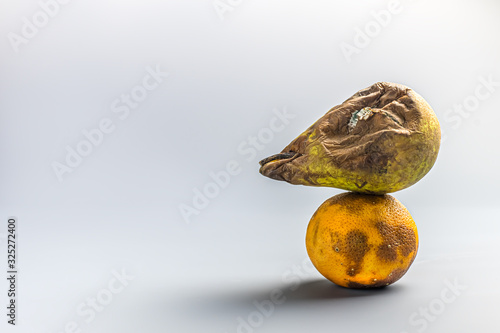 ugly food. spoiled tangerine, orange and pear. mould on products