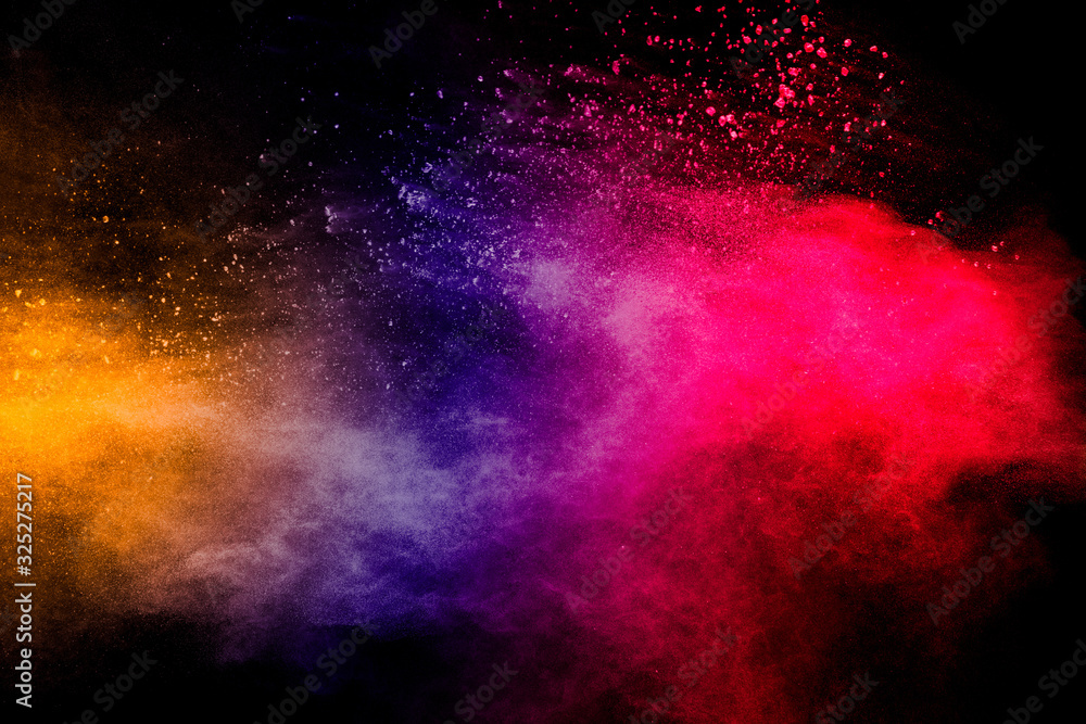 Freeze motion of colorful dust  particles splash. Painted Holi.