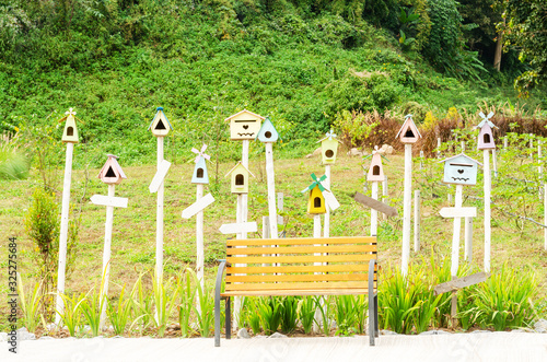little wooden bird house with label in garden