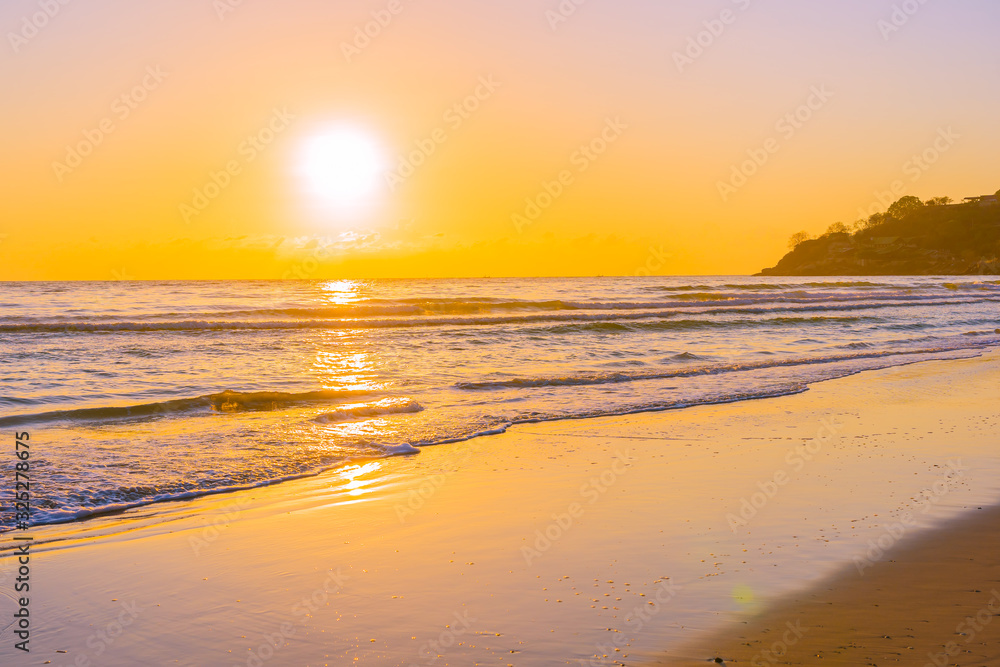 Beautiful tropical beach sea ocean with sunset or sunrise for travel vacation