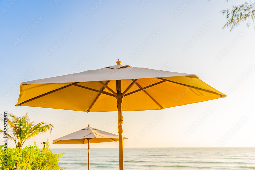 Umbrella and chair around beach sea ocean at sunset or sunrise time Umbrella and chair around beach sea ocean at sunset or sunrise time