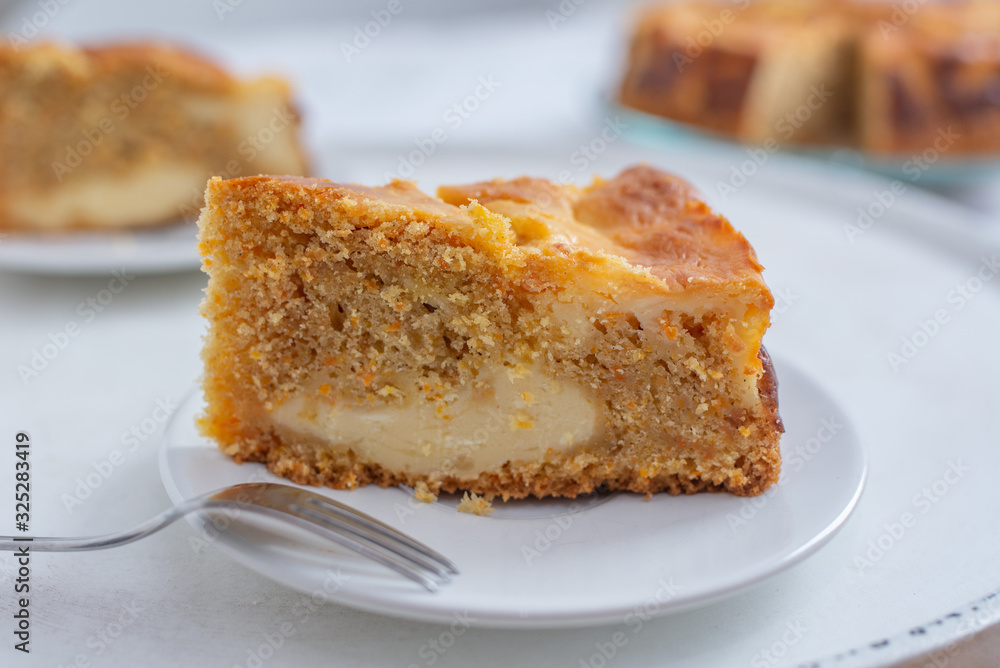 home made carrot cake cheesecake on a table home made carrot cake cheesecake on a table