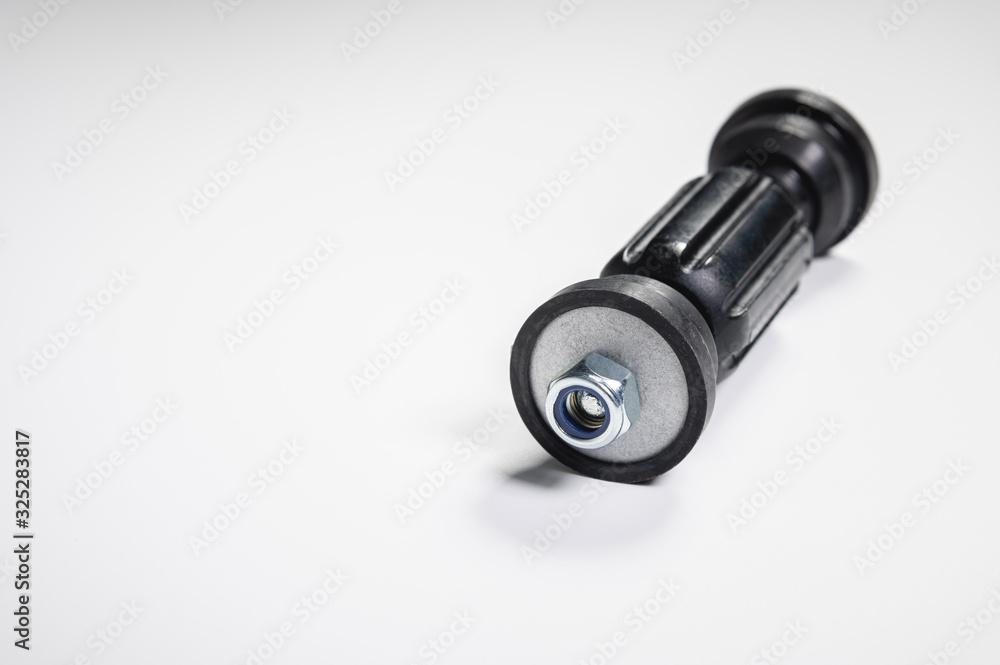 Car front suspension anti-roll bar mount. New tie rod on gray background Car front suspension anti-roll bar mount. New tie rod on gray background