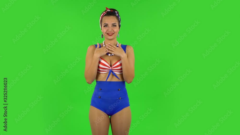 Beautiful girl in a swimsuit says wow, waves his head approvingly and shows thumb like sign. Green screen Beautiful girl in a swimsuit says wow, waves his head approvingly and shows thumb like sign. Green screen