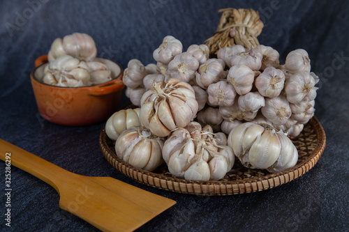 Garlic is placed on the white table in the kitchen, preparing for cooking, Concept: The ingredients of vegetarian ingredients are very much about nature for good health, background  aromatic herbs 