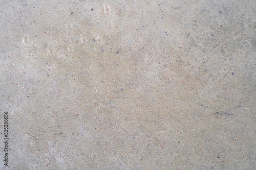 Background with concrete surface with rare debris, dust and leaves.