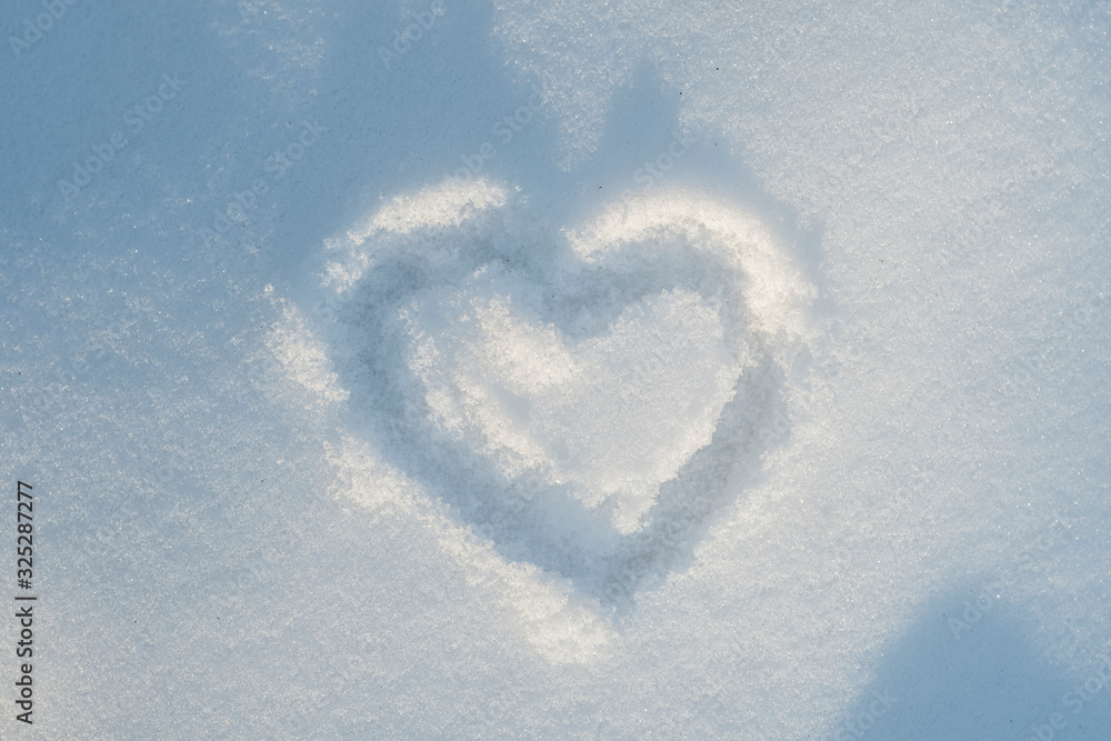 Heart icon carelessly drawn in snow Heart icon carelessly drawn in snow