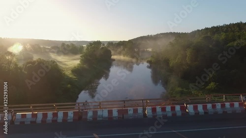 Aerial flight over bridge under construction after car accident. Shot during early morning with fog, not far from Merkine, Lithuania. photo