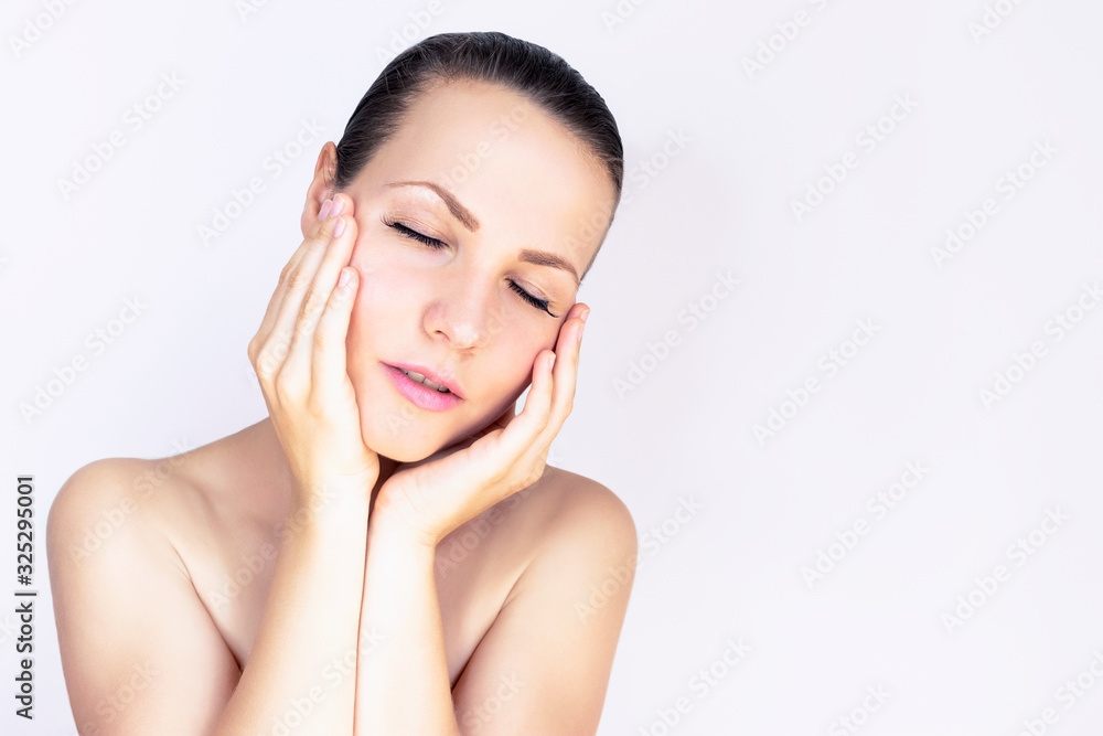 cute, contented pretty girl holding her cheeks face with hands and palms, looking to the side. Expressive facial expressions. Beauty, natural youth, body care, radiant facial skin. Copy space cute, contented pretty girl holding her cheeks face with hands and palms, looking to the side. Expressive facial expressions. Beauty, natural youth, body care, radiant facial skin. Copy space