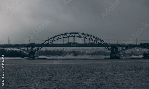 Fototapeta Naklejka Na Ścianę i Meble -  Road bridge in cloudy weather on the background of the Moscow river.