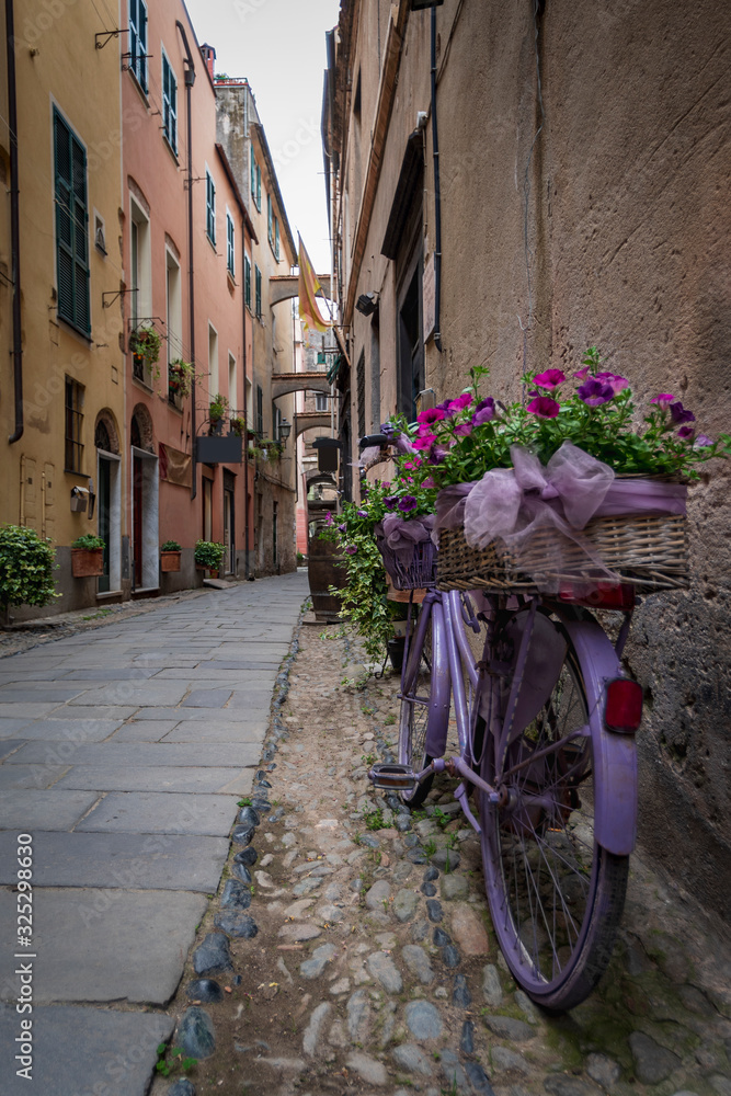 Fototapeta Flower bike in Finalborgo medieval village, Liguria region, Italy