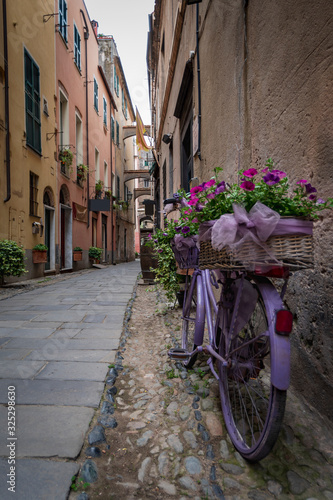 Flower bike in Finalborgo medieval village  Liguria region  Italy