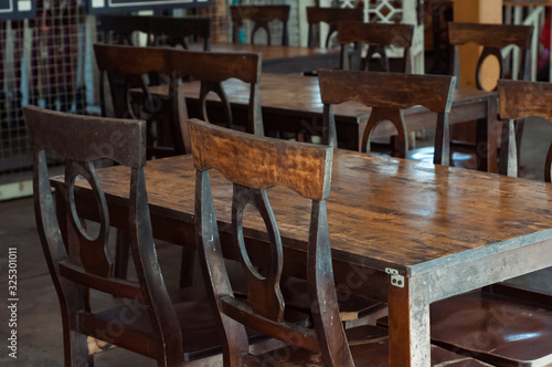 Dark dining table with wooden chair and vintage restaurant.