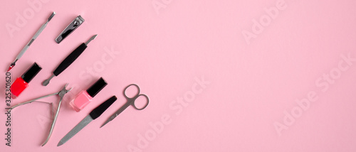 Top view of manicure and pedicure equipment on pink background. Nail salon banner design template. Beauty treatment concept