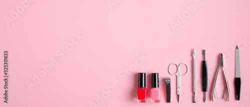 Above view of manicure and pedicure tools on pink background. Nail salon banner design template. Beauty treatment concept