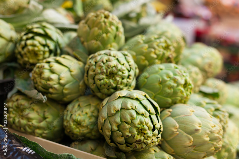 Fresh artichokes on market counter Fresh artichokes on market counter